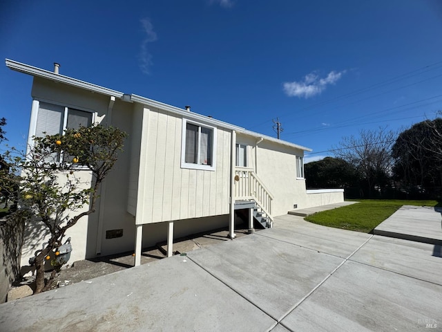 view of property exterior featuring a patio