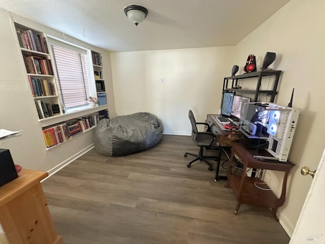 office area with baseboards and wood finished floors