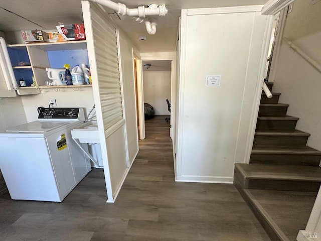 laundry area with laundry area, washer / dryer, dark wood-type flooring, and baseboards