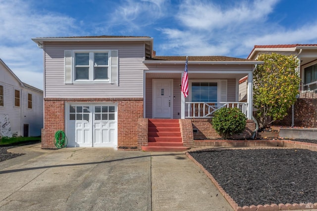 tri-level home with covered porch and brick siding
