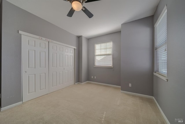 unfurnished bedroom featuring carpet floors, a closet, and baseboards