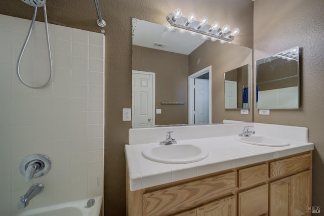 full bathroom featuring visible vents, a sink, shower / tub combination, and double vanity