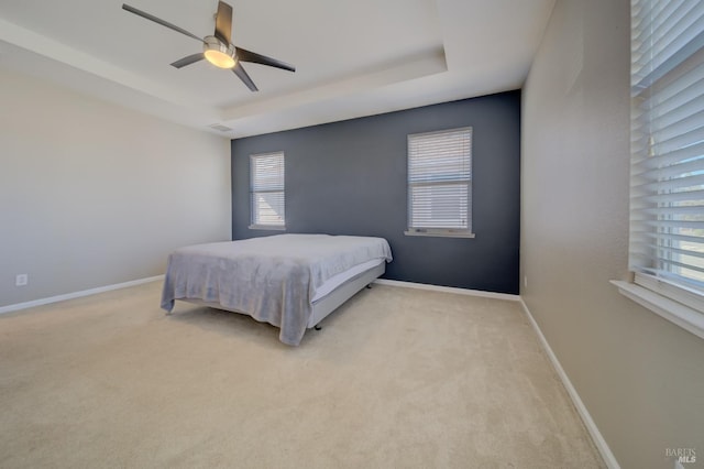 bedroom featuring light carpet, ceiling fan, visible vents, and baseboards