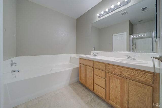 bathroom with a bath, visible vents, and a sink