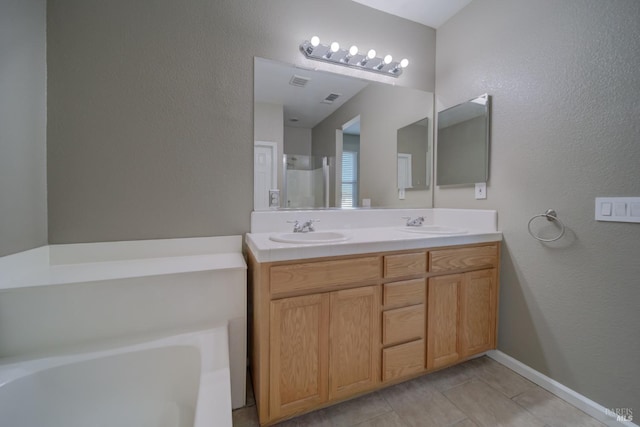 bathroom featuring double vanity, visible vents, a sink, and a bath