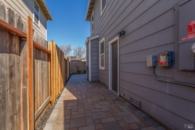 view of home's exterior with fence and a patio