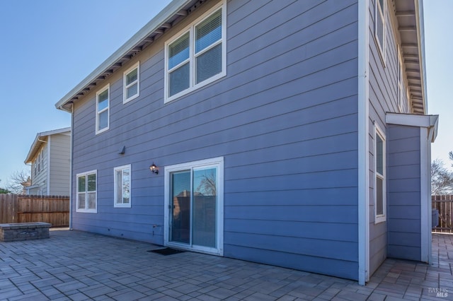 back of property with a patio area and fence