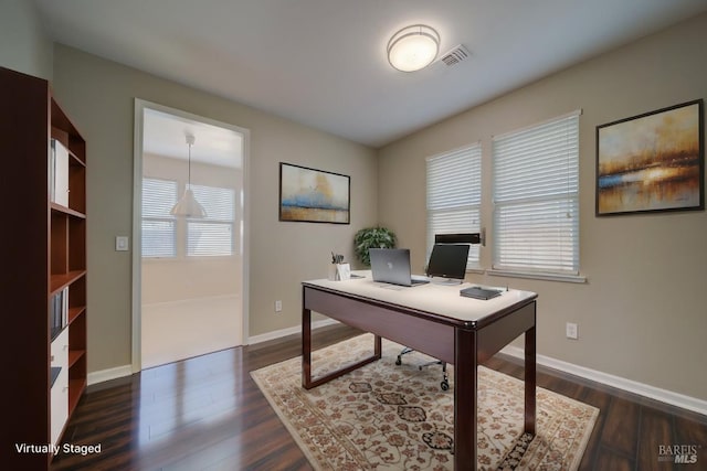 office area featuring dark wood finished floors, visible vents, and baseboards