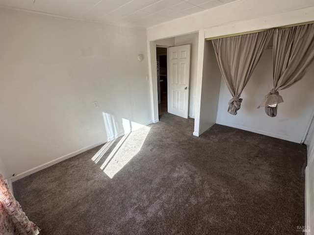 unfurnished bedroom featuring dark colored carpet