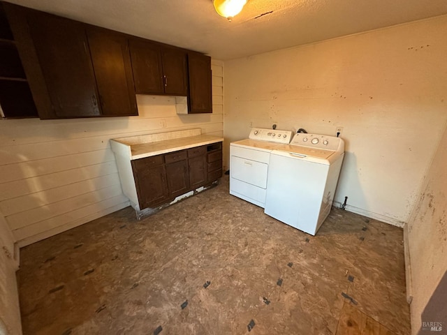 washroom featuring cabinet space and independent washer and dryer