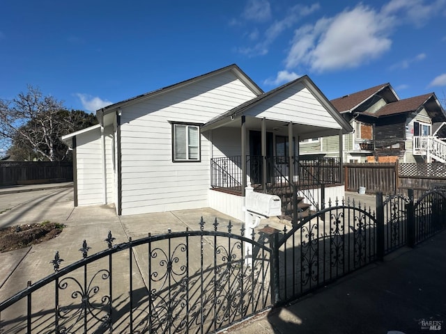 view of front of home with a porch and a fenced front yard