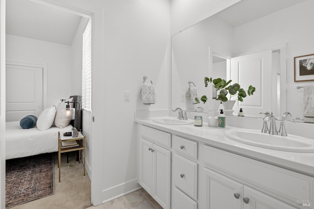 full bathroom with double vanity and a sink