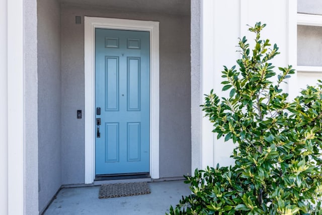 property entrance featuring stucco siding