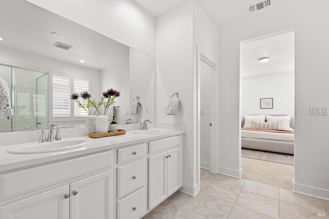 ensuite bathroom with a shower stall, visible vents, a sink, and ensuite bathroom