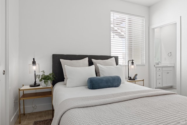 bedroom with a sink, carpet floors, connected bathroom, and baseboards