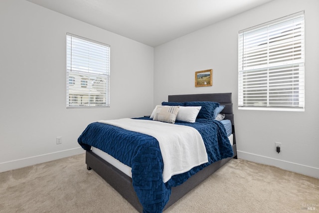 carpeted bedroom with baseboards