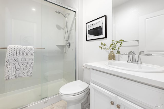 bathroom featuring a stall shower, vanity, toilet, and tile patterned floors