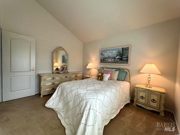 carpeted bedroom with vaulted ceiling