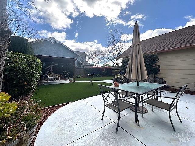 view of patio with fence and outdoor dining area