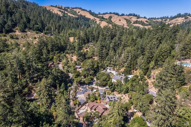 birds eye view of property featuring a view of trees