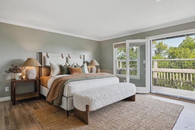 bedroom featuring dark wood-style floors, ornamental molding, baseboards, and access to exterior