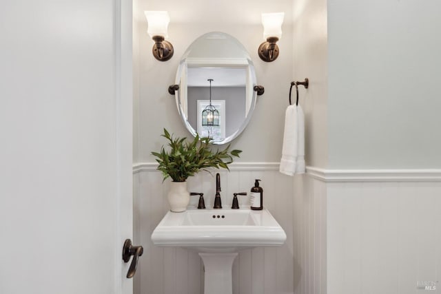 bathroom with wainscoting and a sink