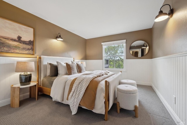 bedroom with a wainscoted wall and carpet flooring