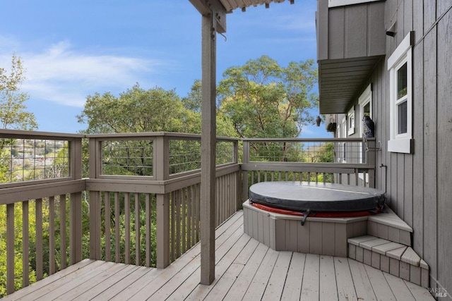 deck with a covered hot tub