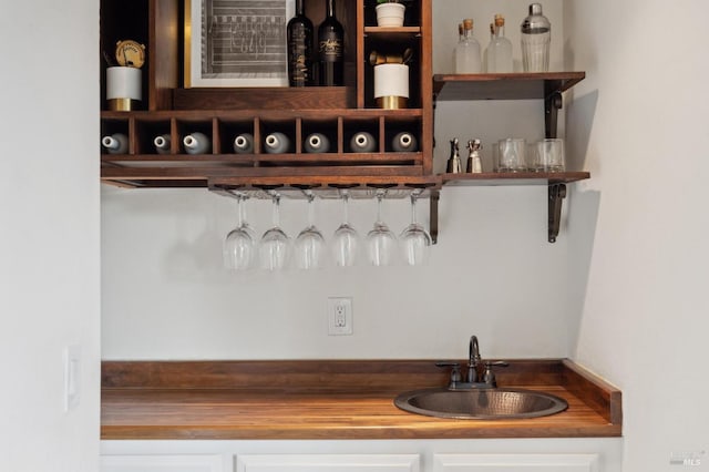 bar featuring indoor wet bar and a sink