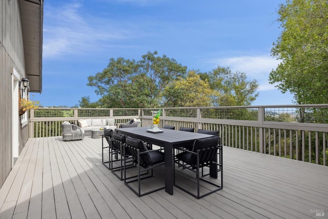 wooden terrace featuring outdoor dining area and an outdoor hangout area