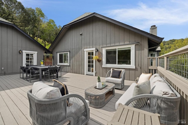 wooden deck featuring outdoor dining space and outdoor lounge area