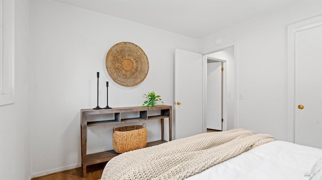 bedroom featuring baseboards and wood finished floors