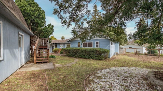 view of yard featuring stairway and fence