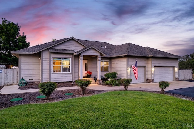 ranch-style house with driveway, fence, a front yard, a shingled roof, and a garage