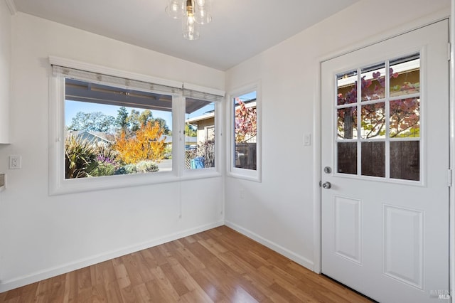 entryway featuring light wood finished floors and baseboards