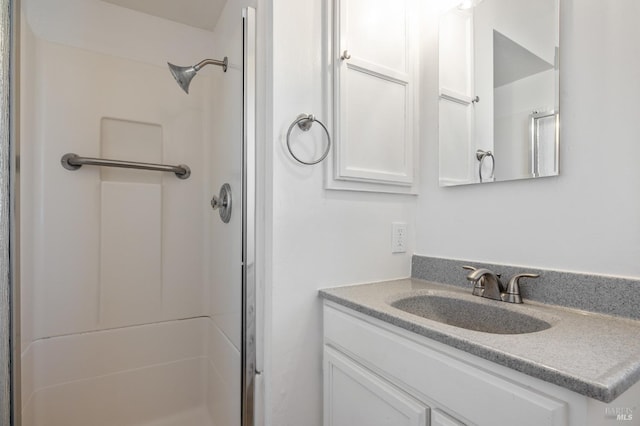 bathroom featuring a shower stall and vanity