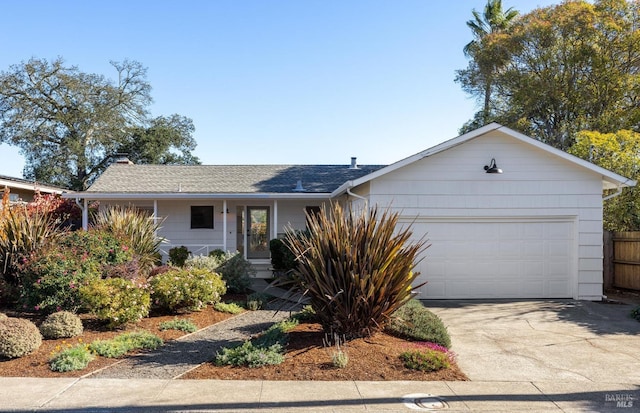 single story home with a garage, covered porch, fence, and concrete driveway