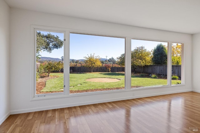 doorway to outside featuring light wood finished floors and baseboards