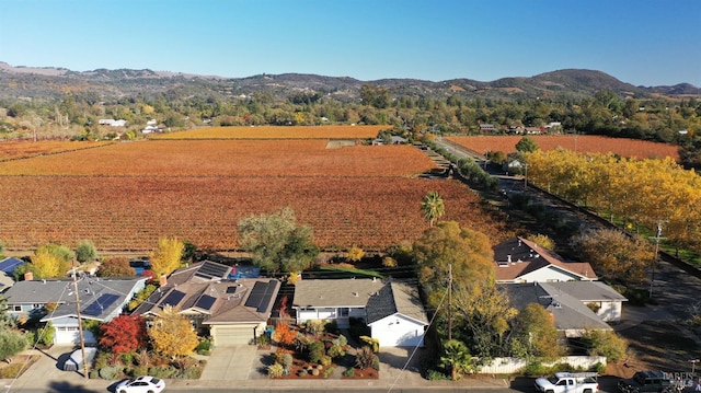 drone / aerial view featuring a residential view, a mountain view, and a rural view