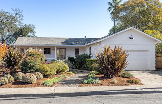 single story home featuring a garage, concrete driveway, and roof with shingles