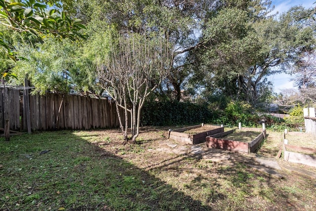 view of yard with a garden and fence