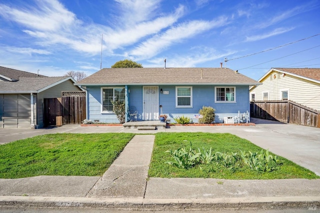 single story home with a front yard and fence