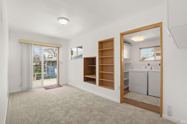 interior space featuring carpet, a healthy amount of sunlight, and independent washer and dryer