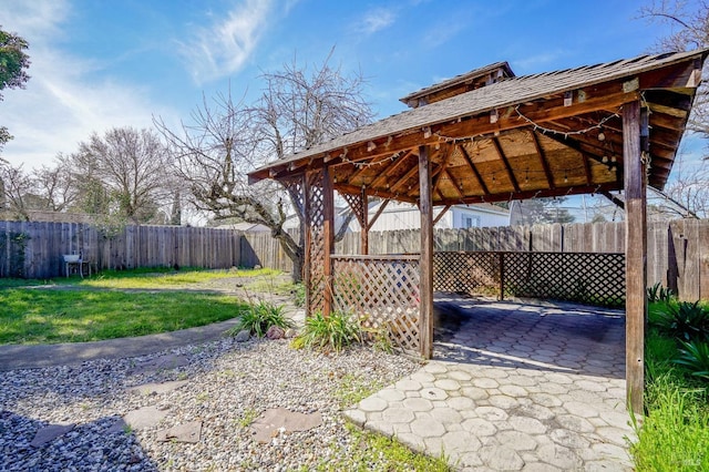 view of yard featuring a gazebo, a carport, a patio area, and a fenced backyard