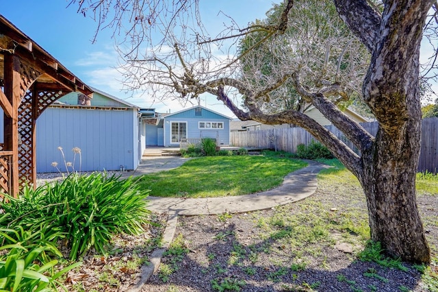 view of yard featuring an outbuilding and fence private yard