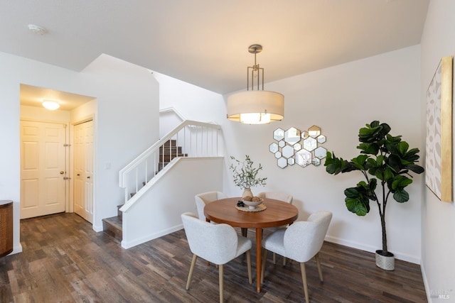 dining area featuring stairs, baseboards, and dark wood-type flooring