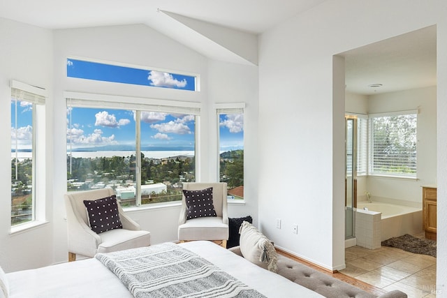 bedroom featuring tile patterned flooring, ensuite bath, and baseboards