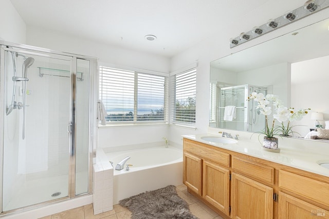 full bathroom with a garden tub, a shower stall, a sink, and tile patterned floors