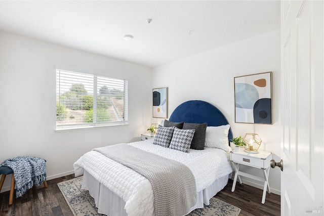 bedroom featuring baseboards and wood finished floors