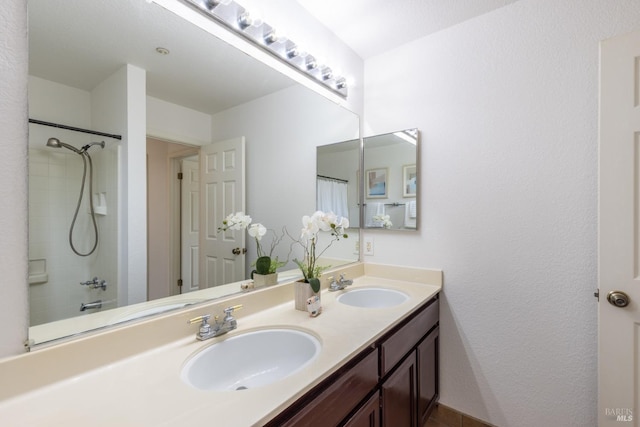 bathroom featuring double vanity, a sink, and a shower with curtain